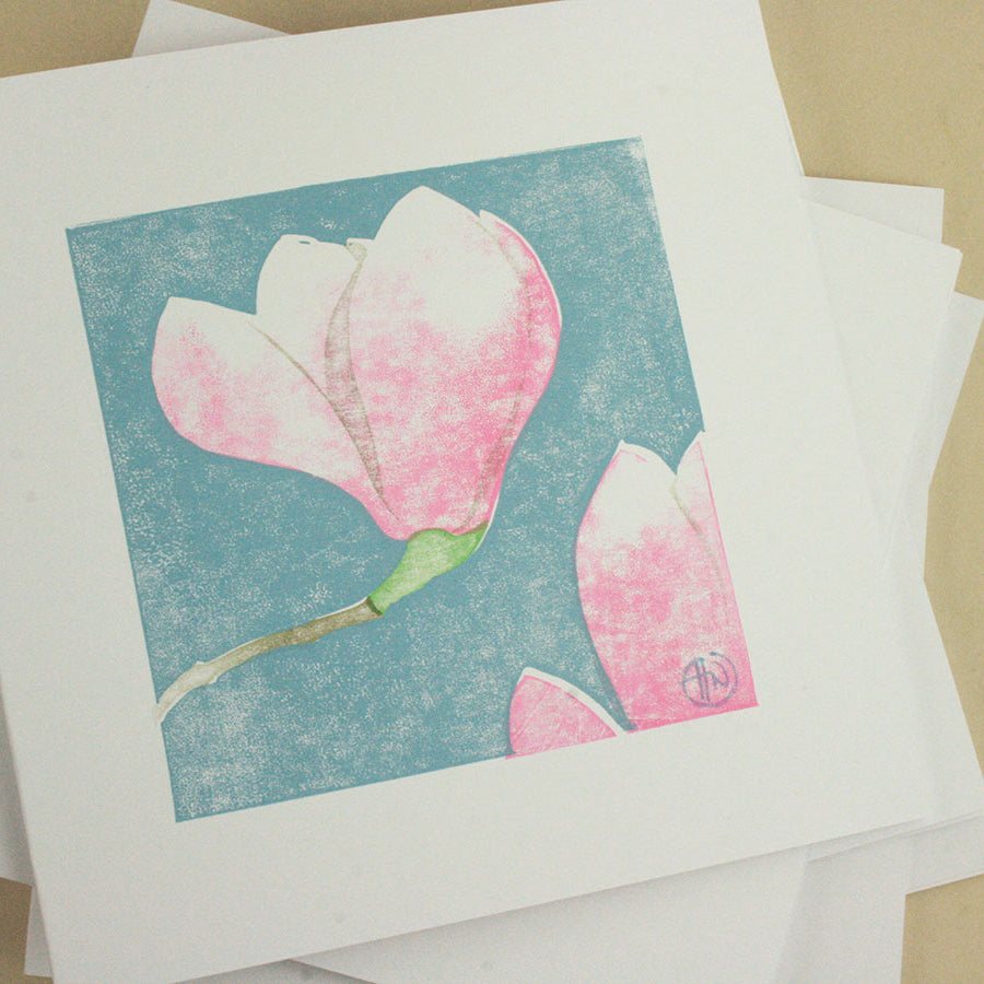 Card with pink floral design on a beige background