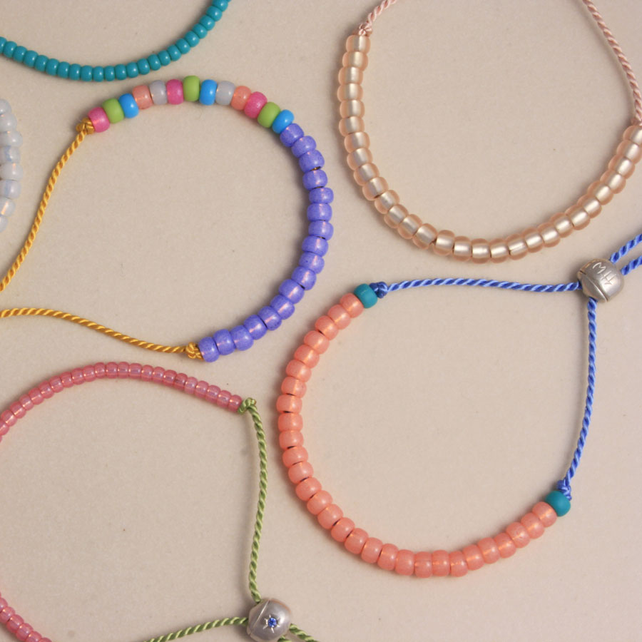 friendship bracelets with brightly coloured glass beads and silk cord